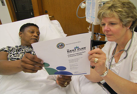 A nurse reviews The Daily Plan with a Veteran patient. 