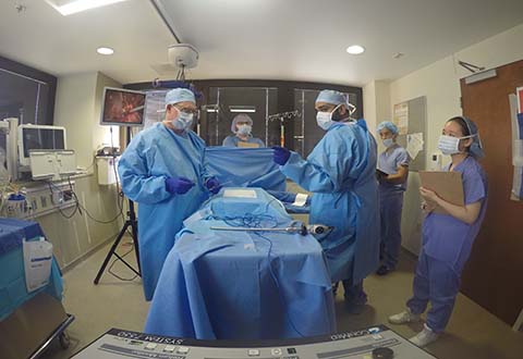 A group of clinicians test medical projects in an operating room environment.