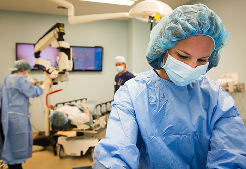 A healthcare team prepares a patient for surgery in the operating room.