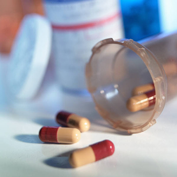 Pills spilling from a container.