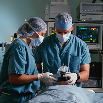 A nurse and a doctor with a patient in an operating room.
